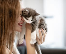 girl holding kitten